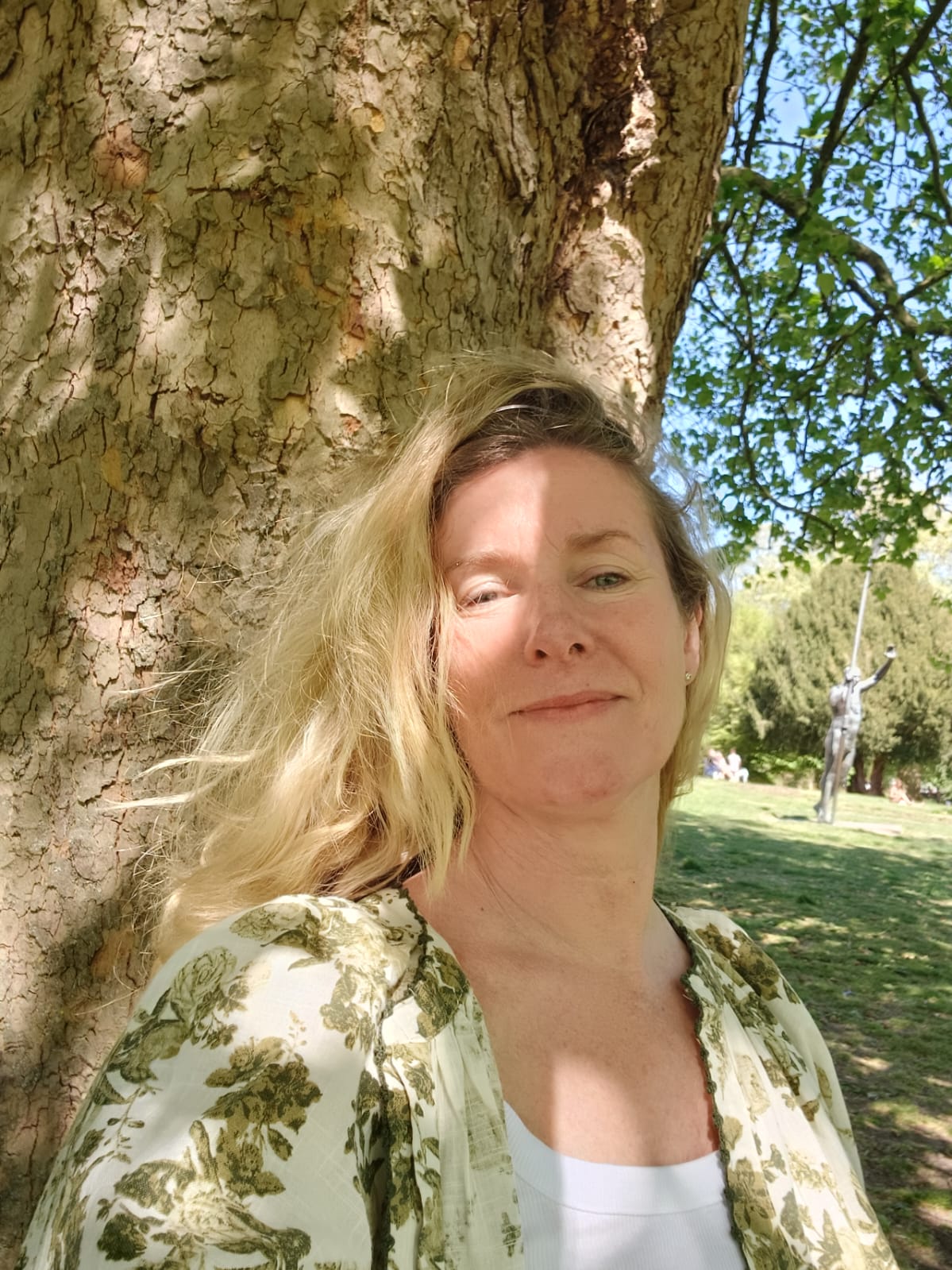 Katharine Gailard outdoors, leaning against an old tree near Marlow